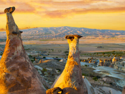 Rocks looking like mushrooms dramatically lit by a sunset in Cappadocia